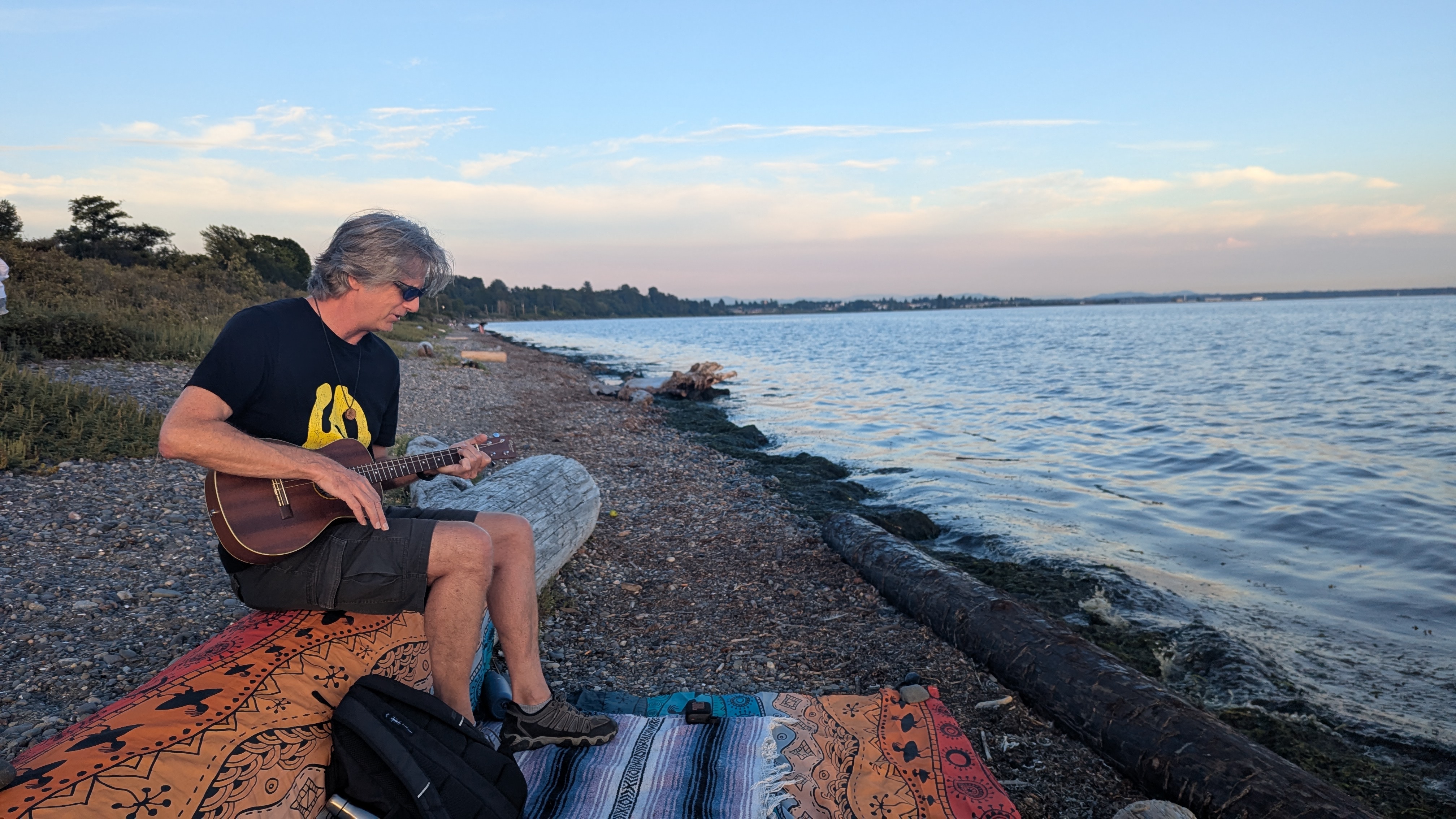 FIRST BUZZ playing baritone ukulele on the beach