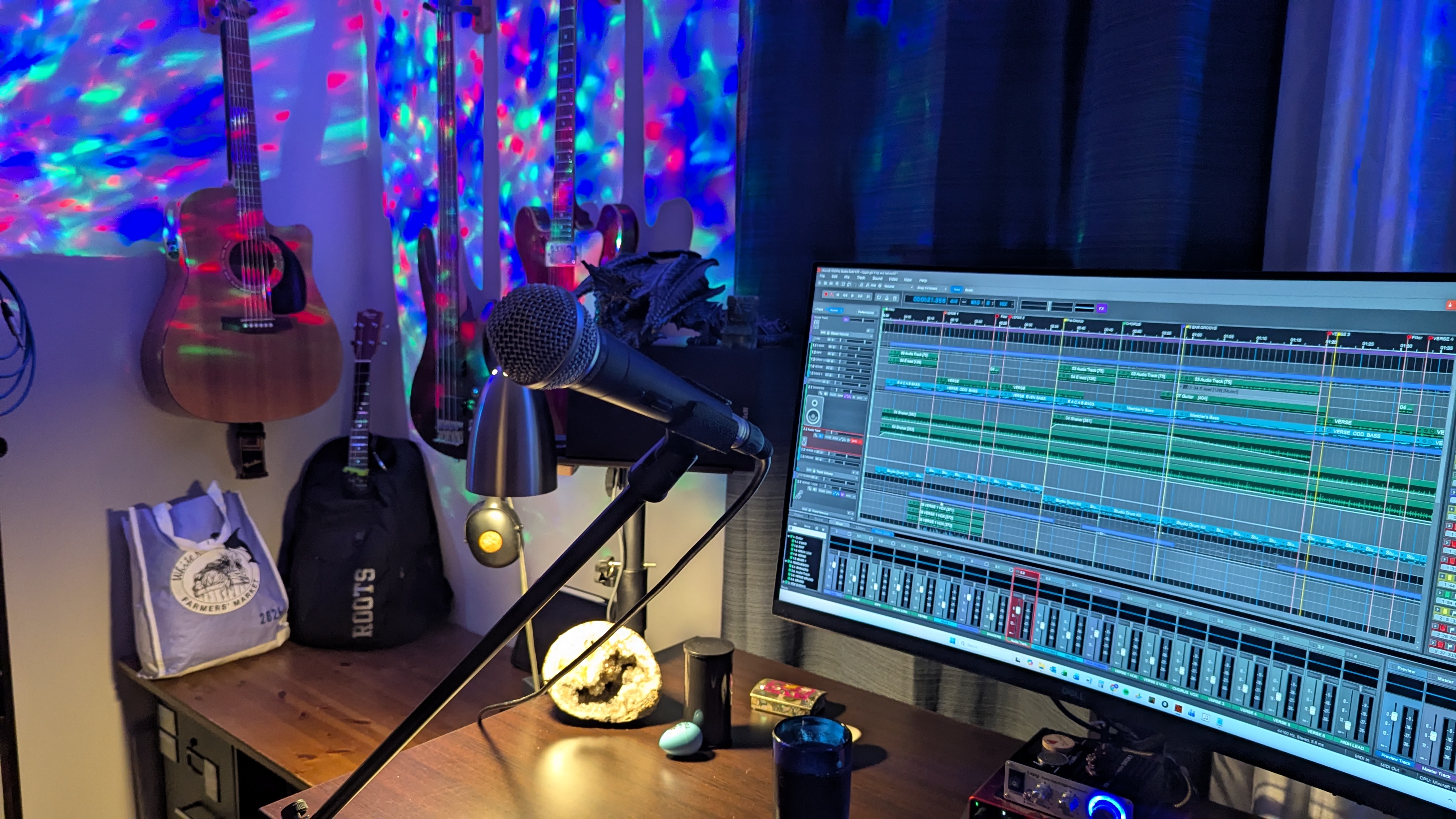 FIRST BUZZ's home studio with guitars, microphone and recording session open on the computer